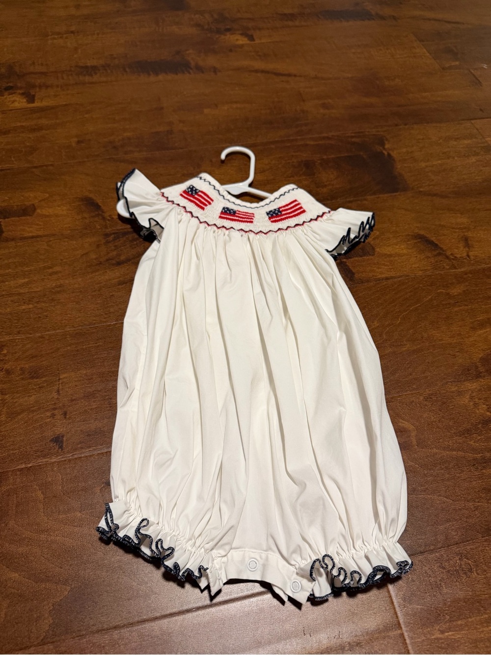 Smocked Ivory Baby Romper with Flag Detail